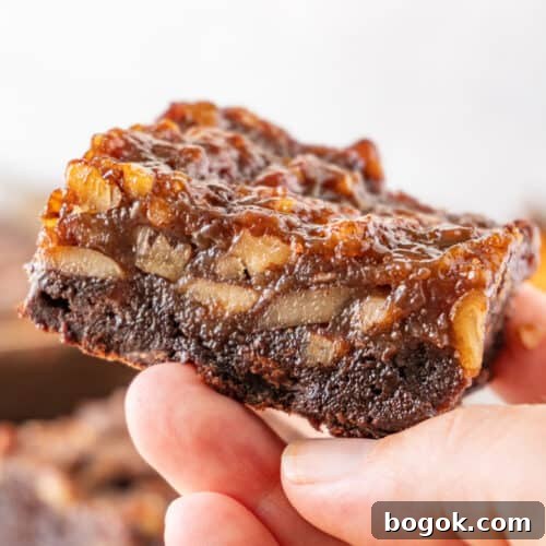 Pecan Pie Brownies featured image- holding brownie in hand