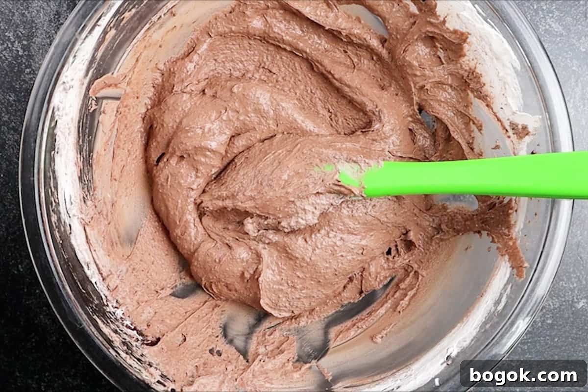 pudding mixture with cool whip folded in, in a glass bowl.