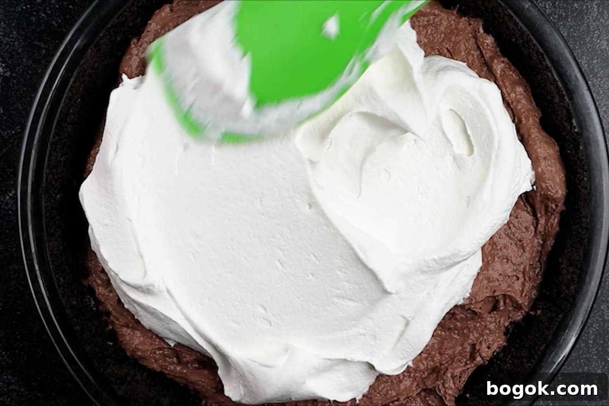 spreading cool whip on top of pie