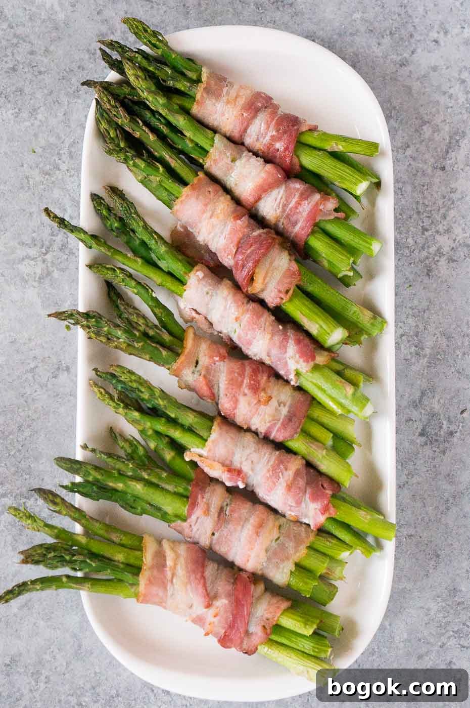 asparagus wrapped in bacon on a plate