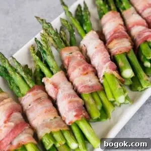 bacon wrapped asparagus bundles on a platter