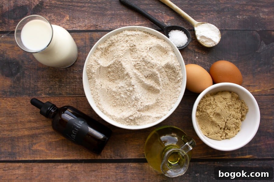 a bowl of whole wheat flour, brown sugar, with spoons of baking powder salt, vanilla, milk, and 2 eggs