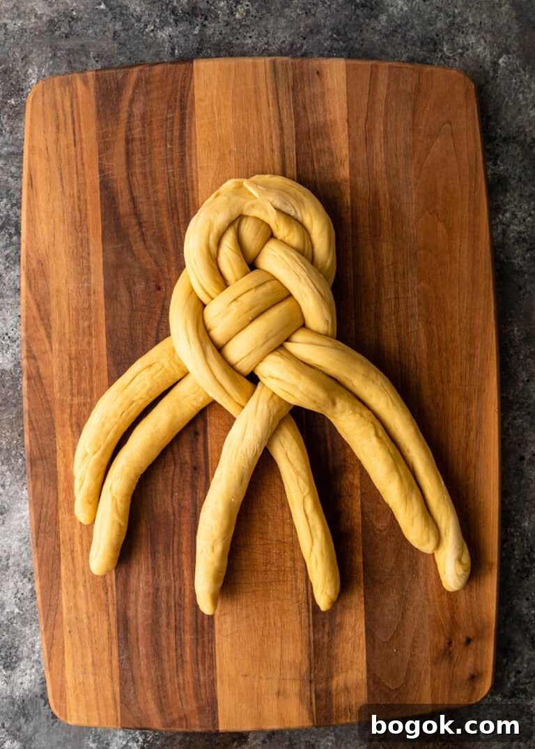 Authentic Challah Recipe: Soft, Braided Jewish Bread Tutorial 16 overhead process shot: dough rolled into six equal ropes tapered edges in the middle dough being braided