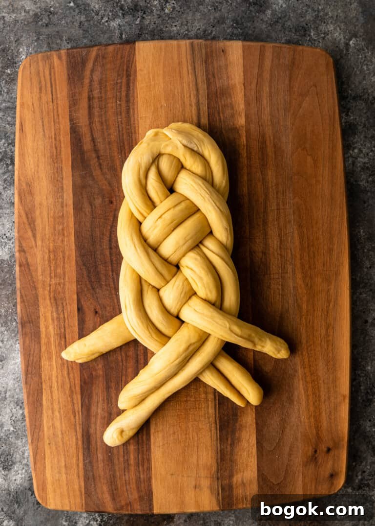 Authentic Challah Recipe: Soft, Braided Jewish Bread Tutorial 17 overhead process shot: dough rolled into six equal ropes tapered edges in the middle dough being braided
