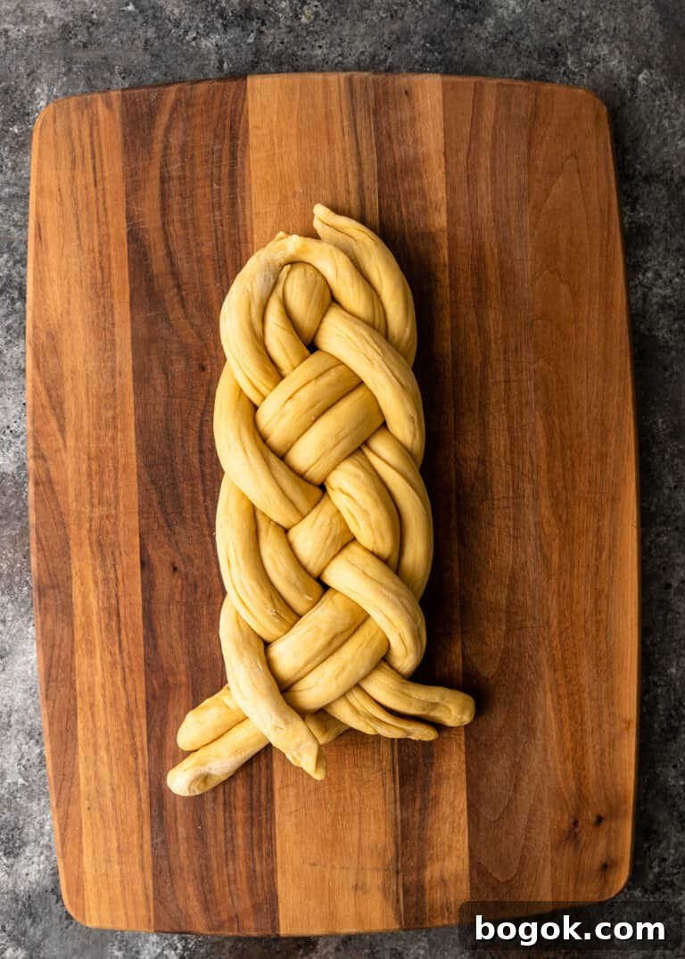 Authentic Challah Recipe: Soft, Braided Jewish Bread Tutorial 18 overhead process shot: dough rolled into six equal ropes tapered edges in the middle dough being braided