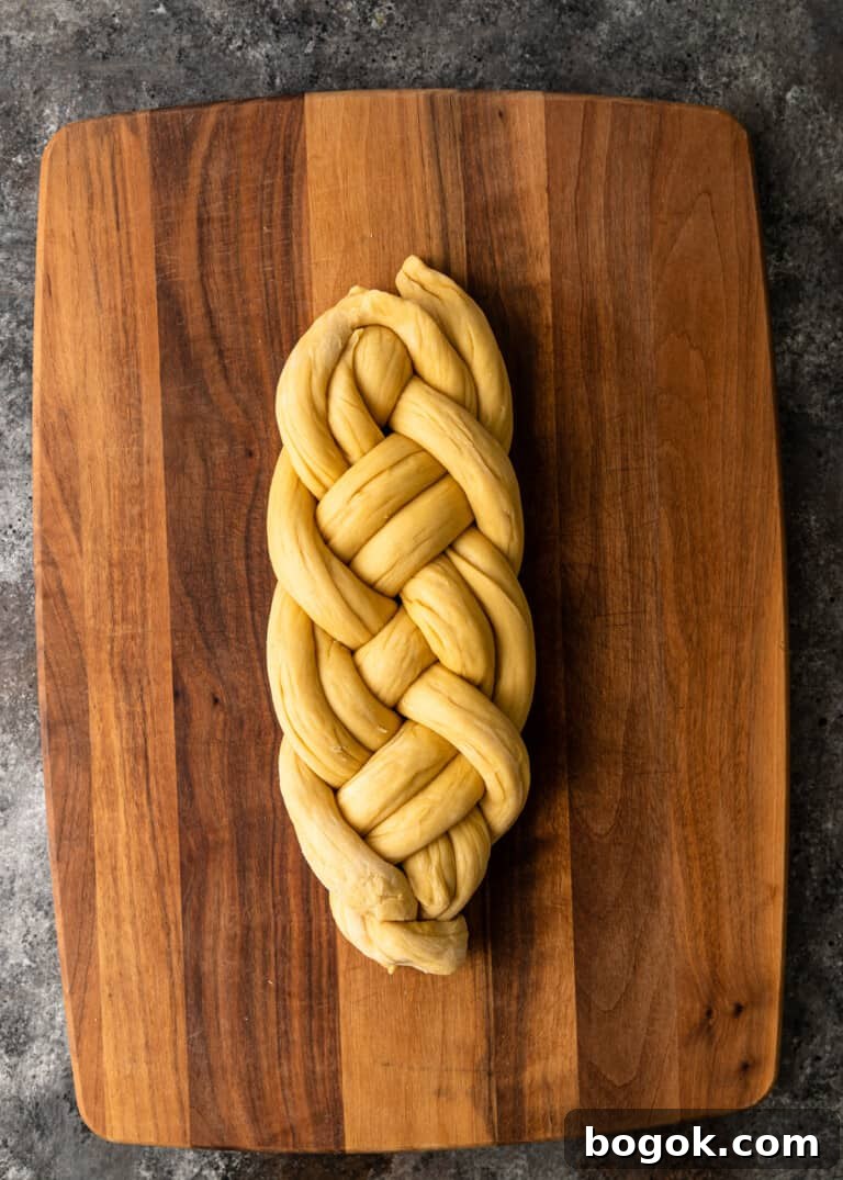 Authentic Challah Recipe: Soft, Braided Jewish Bread Tutorial 19 overhead process shot: dough rolled into six equal ropes tapered edges in the middle dough being braided