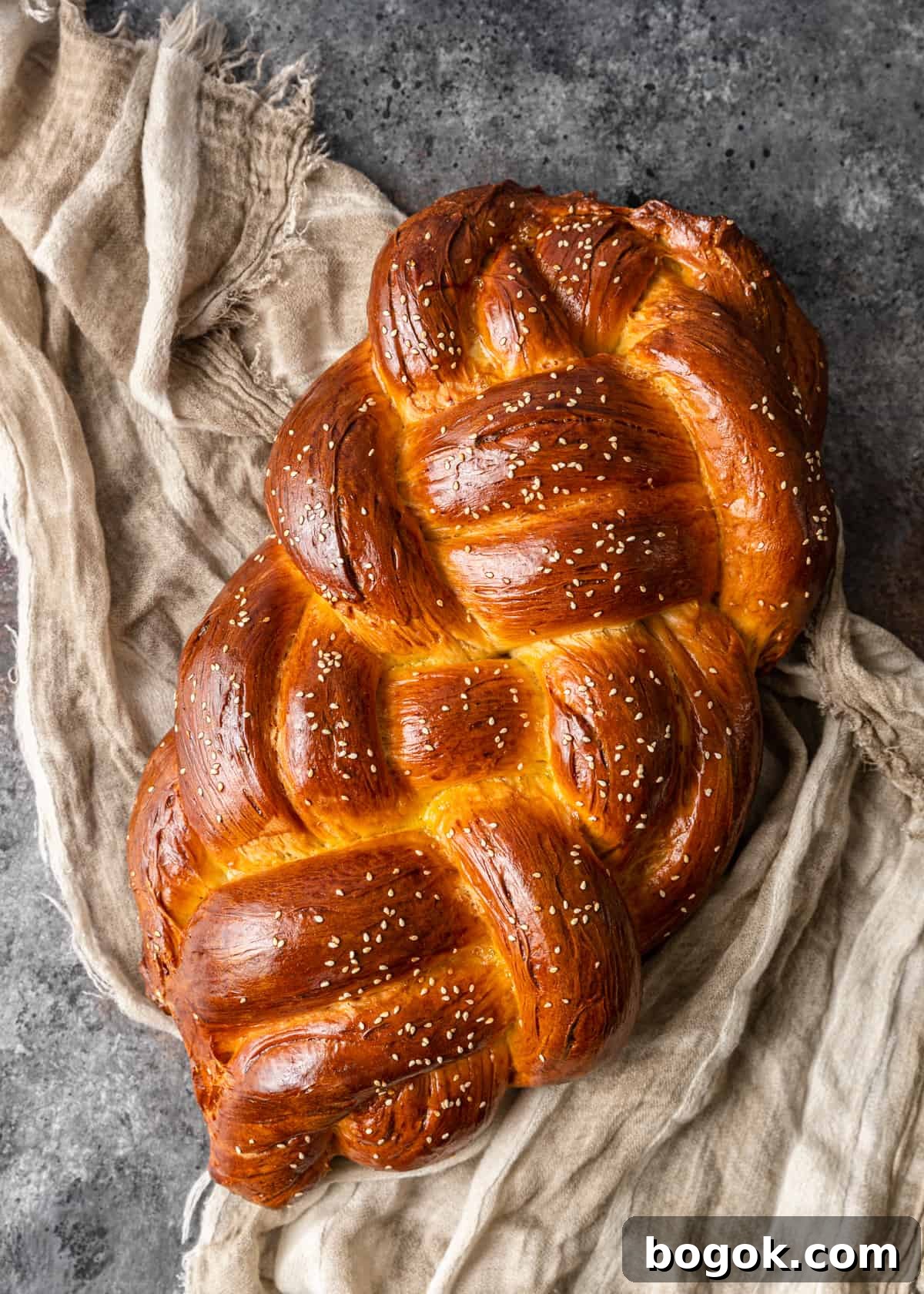 Authentic Challah Recipe: Soft, Braided Jewish Bread Tutorial 24 overhead: finished challah bread on tea towel