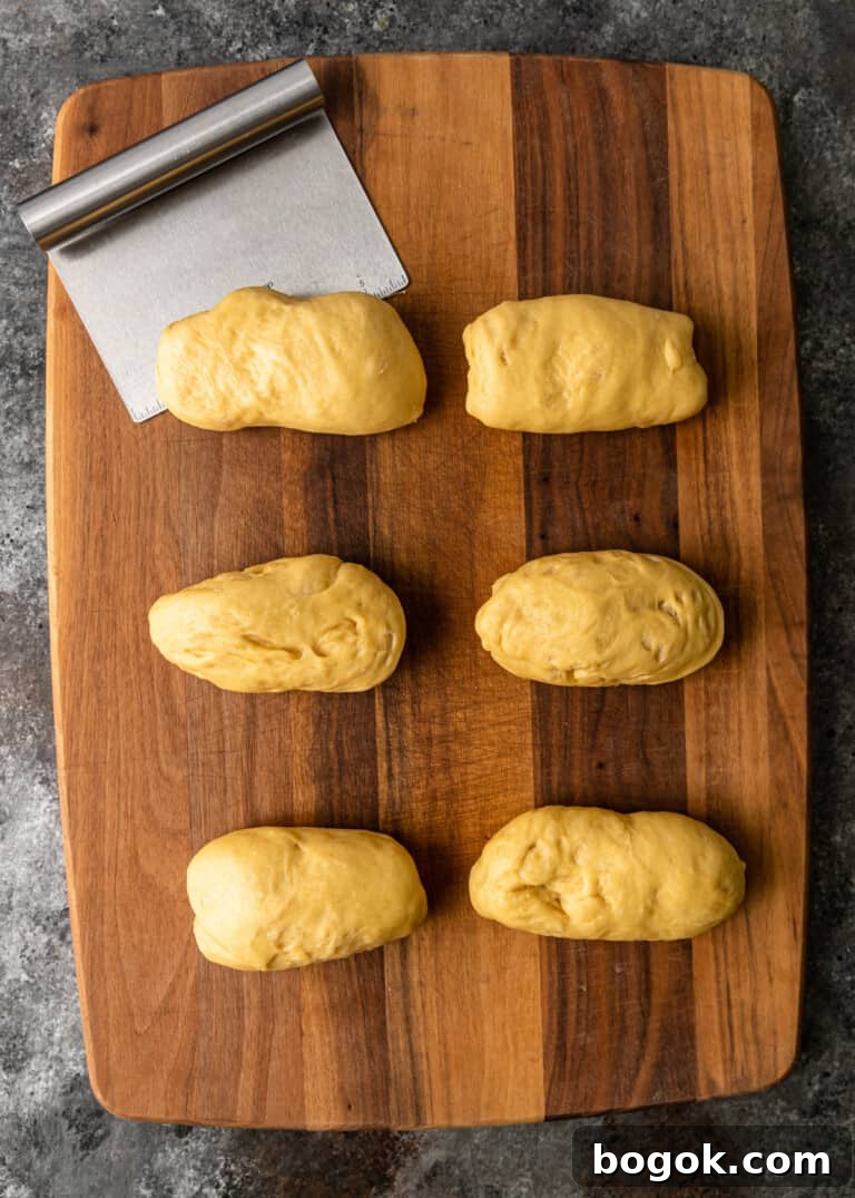 Authentic Challah Recipe: Soft, Braided Jewish Bread Tutorial 8 overhead process shot: dough cut into six equal pieces and shaped into rectangles on cutting board