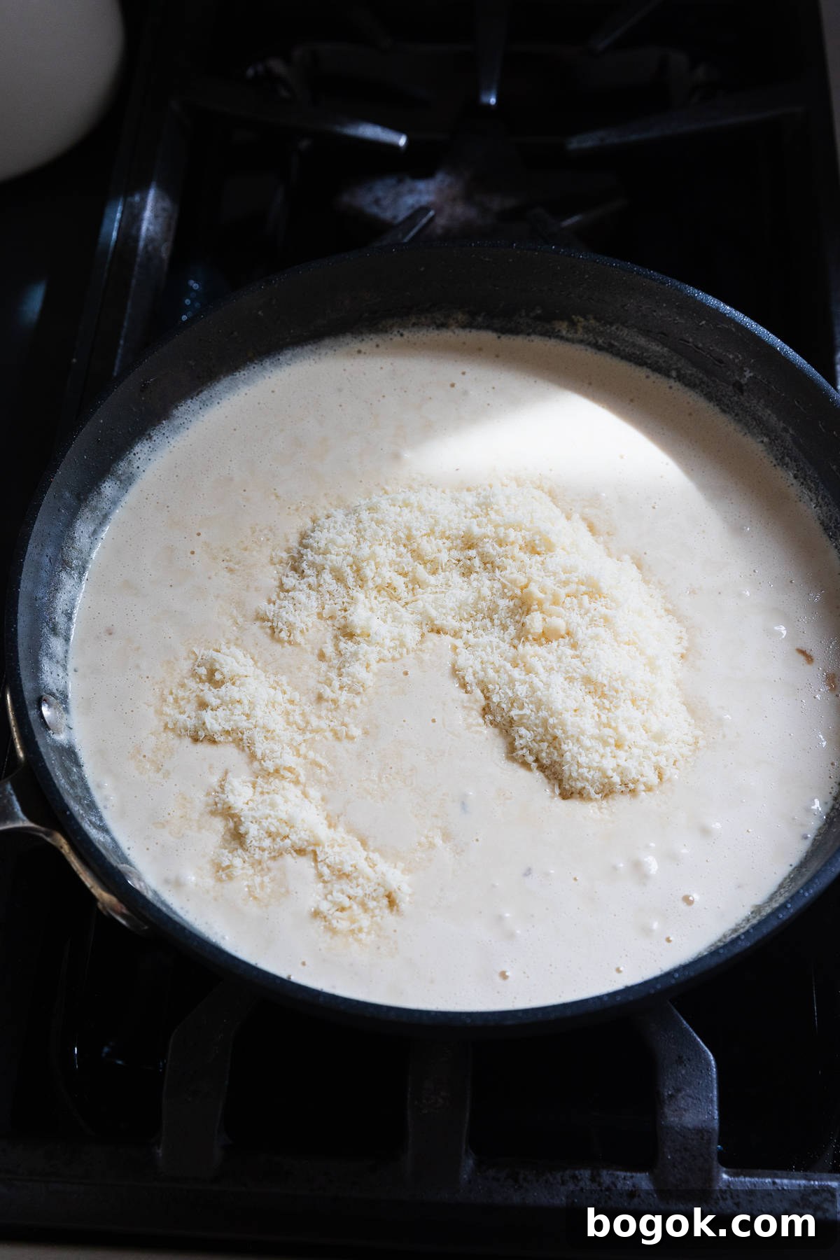 Lighter Chicken Fettuccine Alfredo Recipe (Olive Garden Style) 8 Parmesan cheese added to make alfredo sauce.