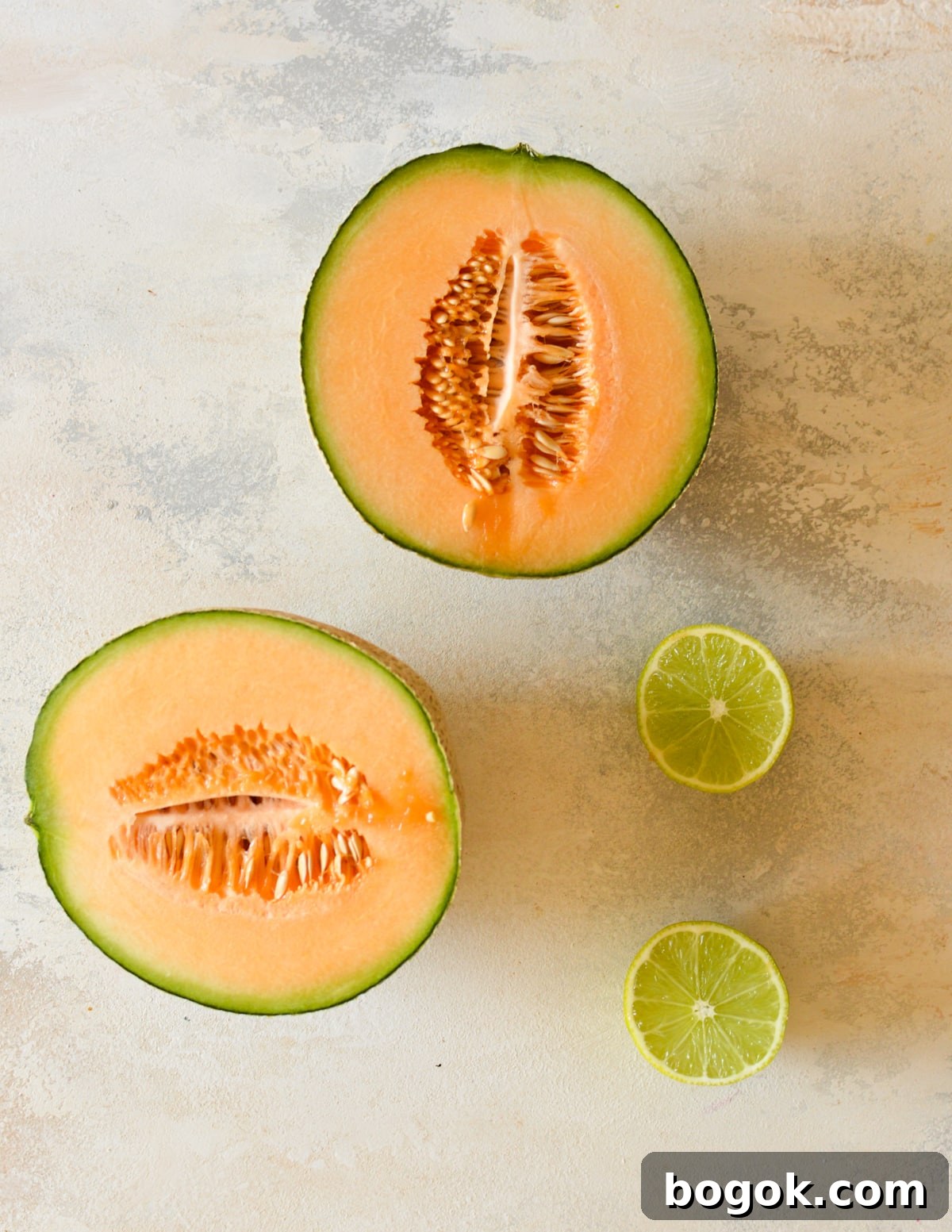 Refreshing Cantaloupe Juice Recipe: Cold, Natural & Delicious 3 a cantaloupe cut in half and a lime.