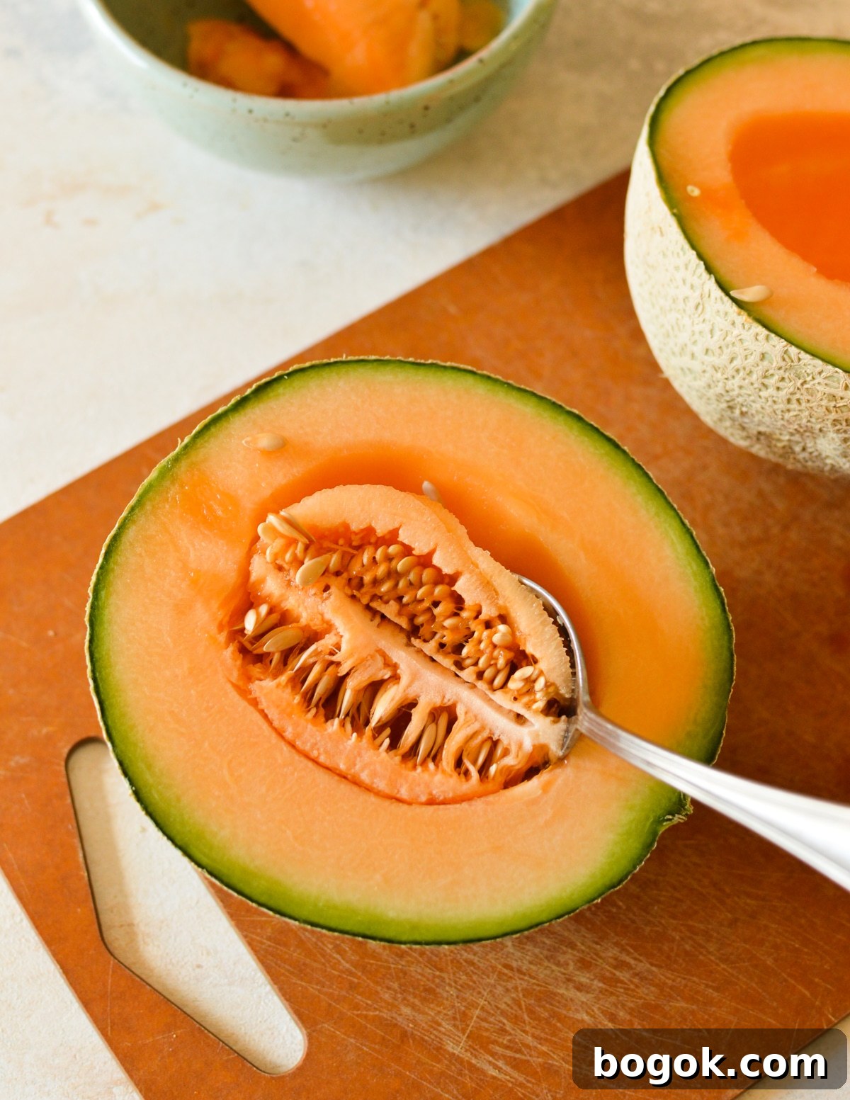 Refreshing Cantaloupe Juice Recipe: Cold, Natural & Delicious 4 half a cantaloupe with a spoon in it.