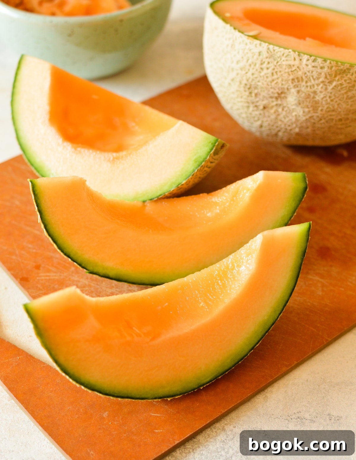Refreshing Cantaloupe Juice Recipe: Cold, Natural & Delicious 7 cantaloupe slices on cutting board,