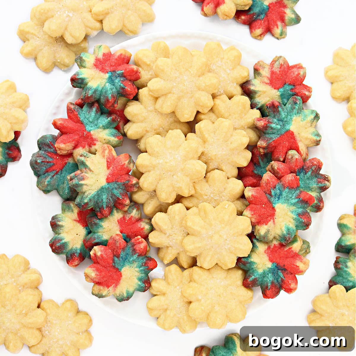 Spritz cookies in flower shapes on a plate.