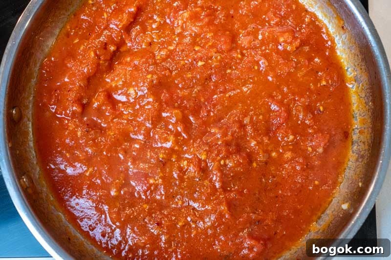 Spicy Spaghetti all'Arrabbiata Recipe with Garlic and Chili 5 Adding the crushed tomatoes