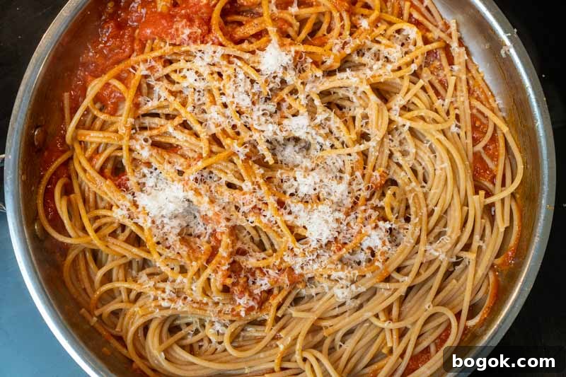 Spicy Spaghetti all'Arrabbiata Recipe with Garlic and Chili 6 Stirring in the spaghetti & cheese