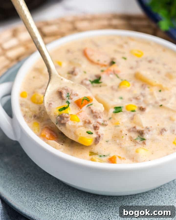 A bowl of crockpot creamy hamburger and potato soup.