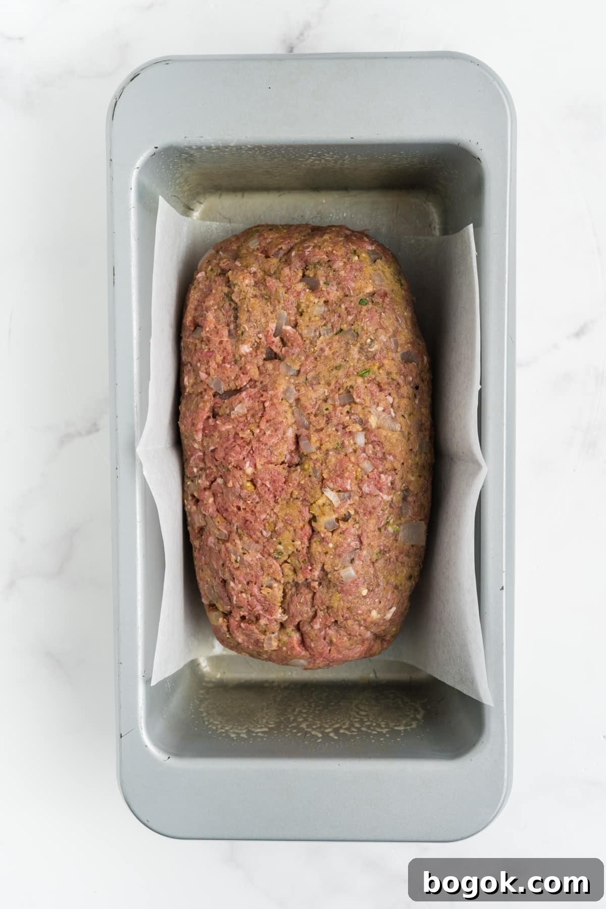 The meat mixture in a loaf pan.
