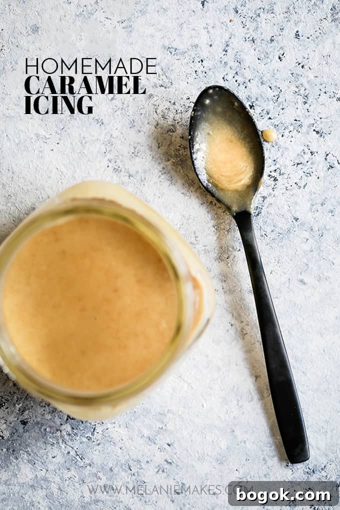 This Homemade Caramel Icing recipes takes just seven minutes to prepare and uses only five ingredients. EASY. If you can use a whisk, you'll be an icing expert for sure. A black spoon with Homemade Caramel Icing sits on a speckled background with a glass jar full of icing.