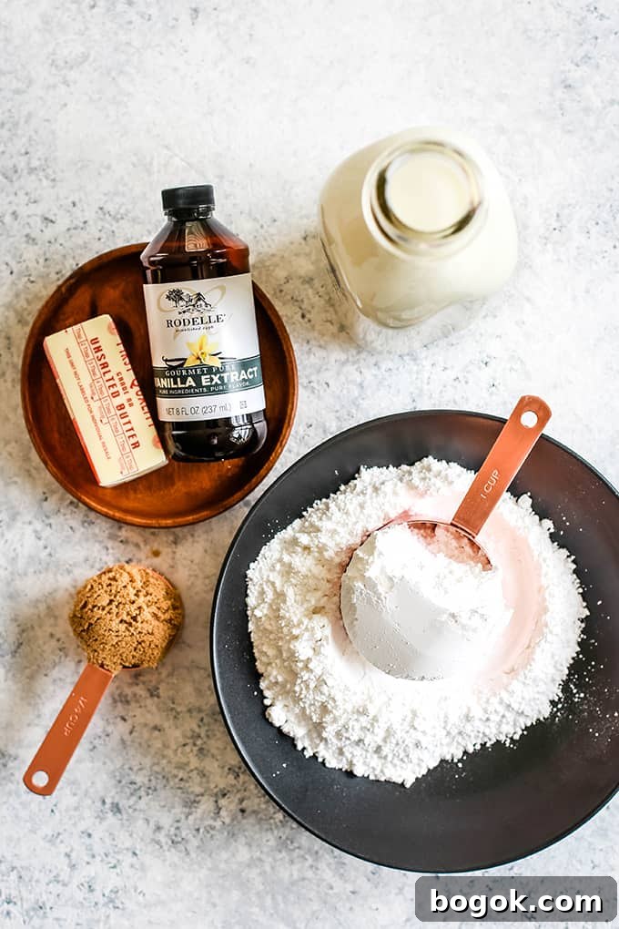 This Homemade Caramel Icing recipes takes just seven minutes to prepare and uses only five ingredients. EASY. If you can use a whisk, you'll be an icing expert for sure. All of the ingredients needed to make Homemade Caramel Icing on a speckled background.