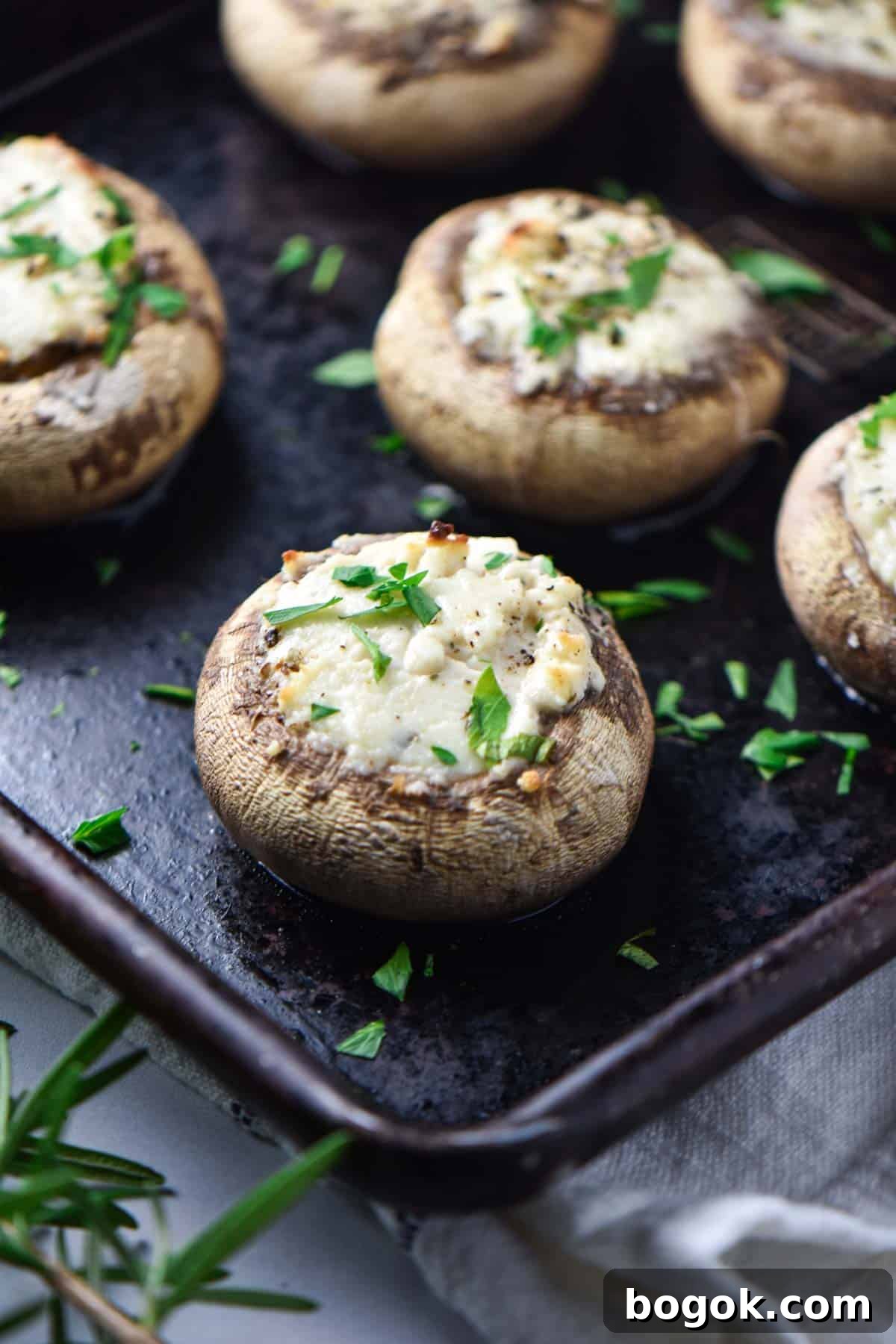 Boursin-Stuffed Mushrooms with Garlic and Herbs 7 Cheese stuffed mushrooms on a baking sheet after baking.