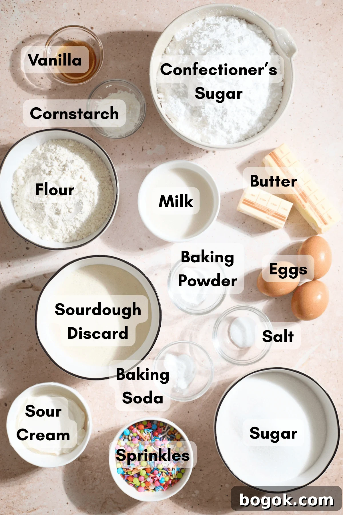 Ingredients for Sourdough Vanilla Cupcakes in small bowls.