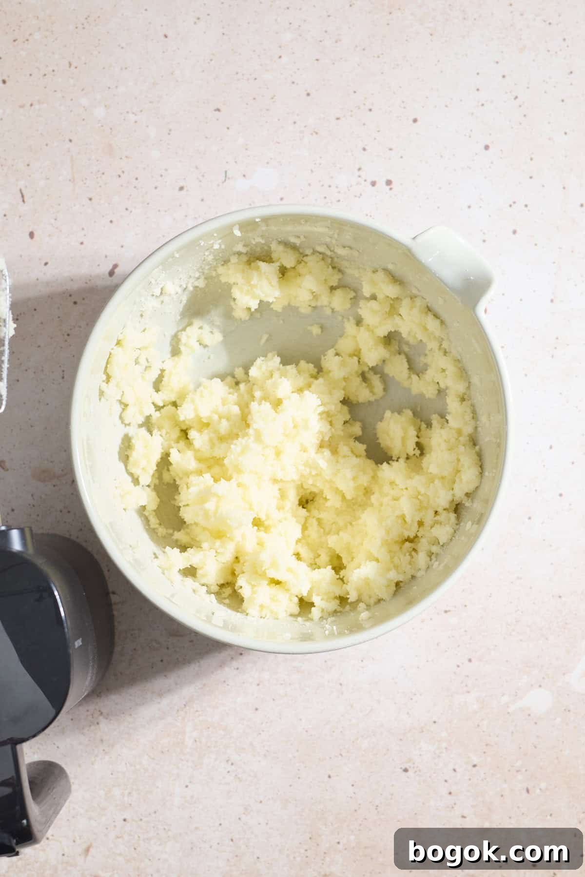 Butter and sugar creamed in a large mixing bowl.