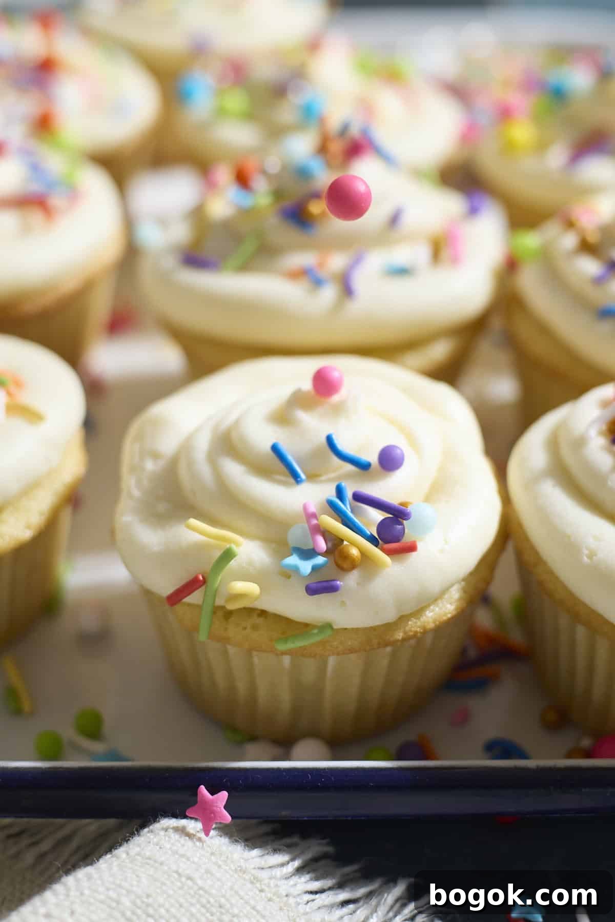 Sprinkles being poured on the cupcake.