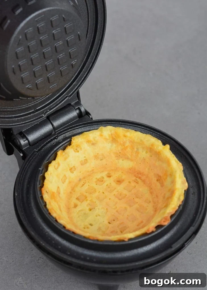 Learn how to make a chaffle bowl for a fun low carb meal prep! This easy keto chaffle bread bowl is great for salads, breakfast bowls, and more!