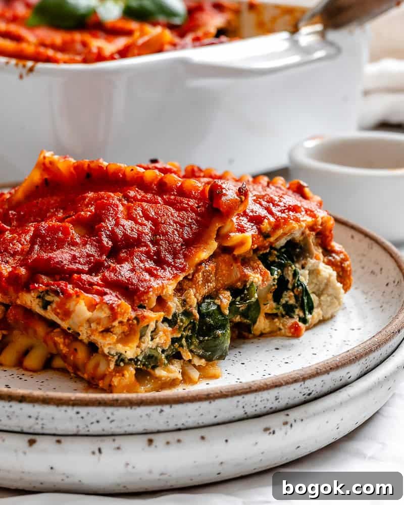 a piece of vegan lasagna on a white plate.