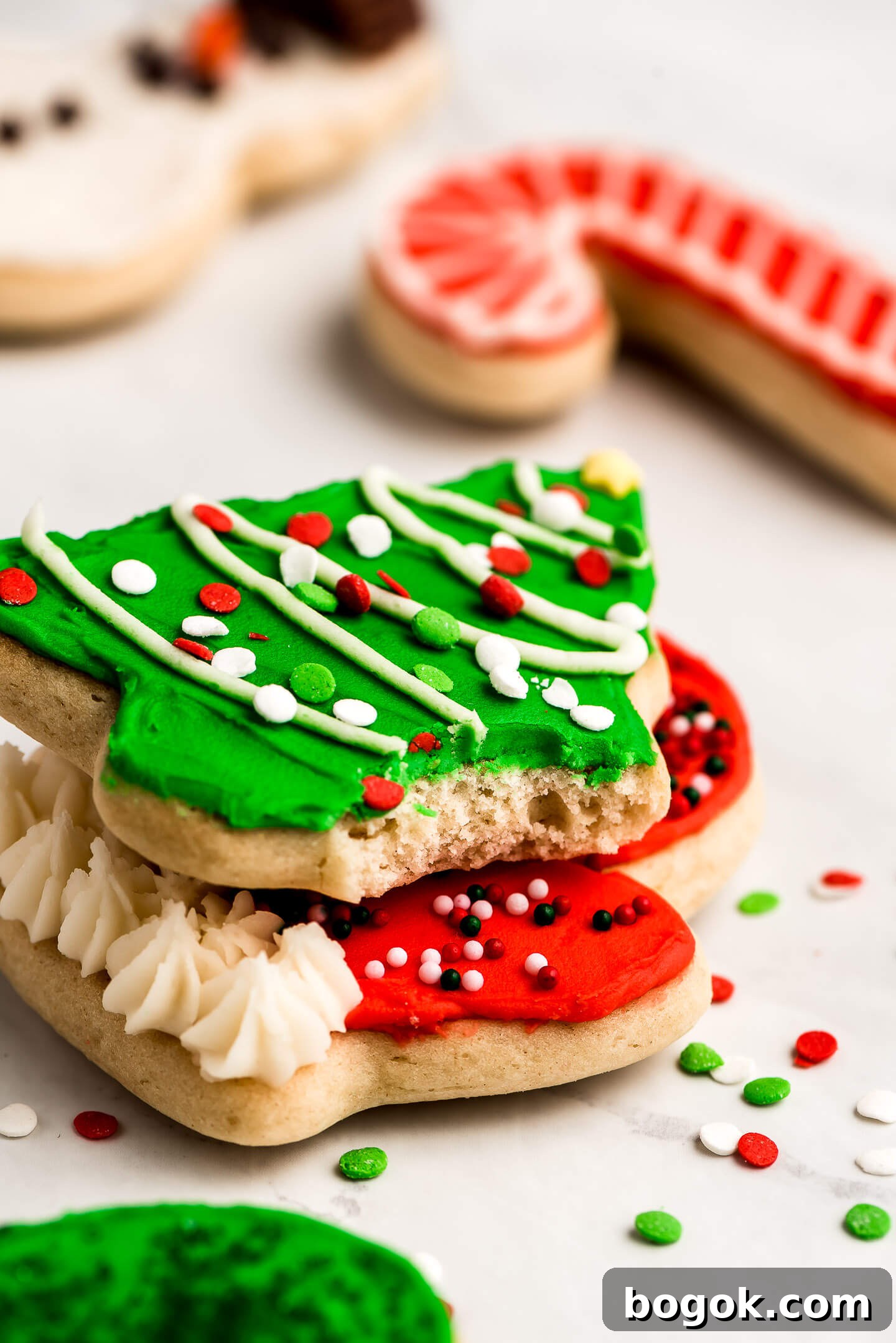 Christmas Sugar Cookie Recipes for Festive Decorating and Gifts 7 A soft sugar cookie in the shape of a tree with a bite taken out.