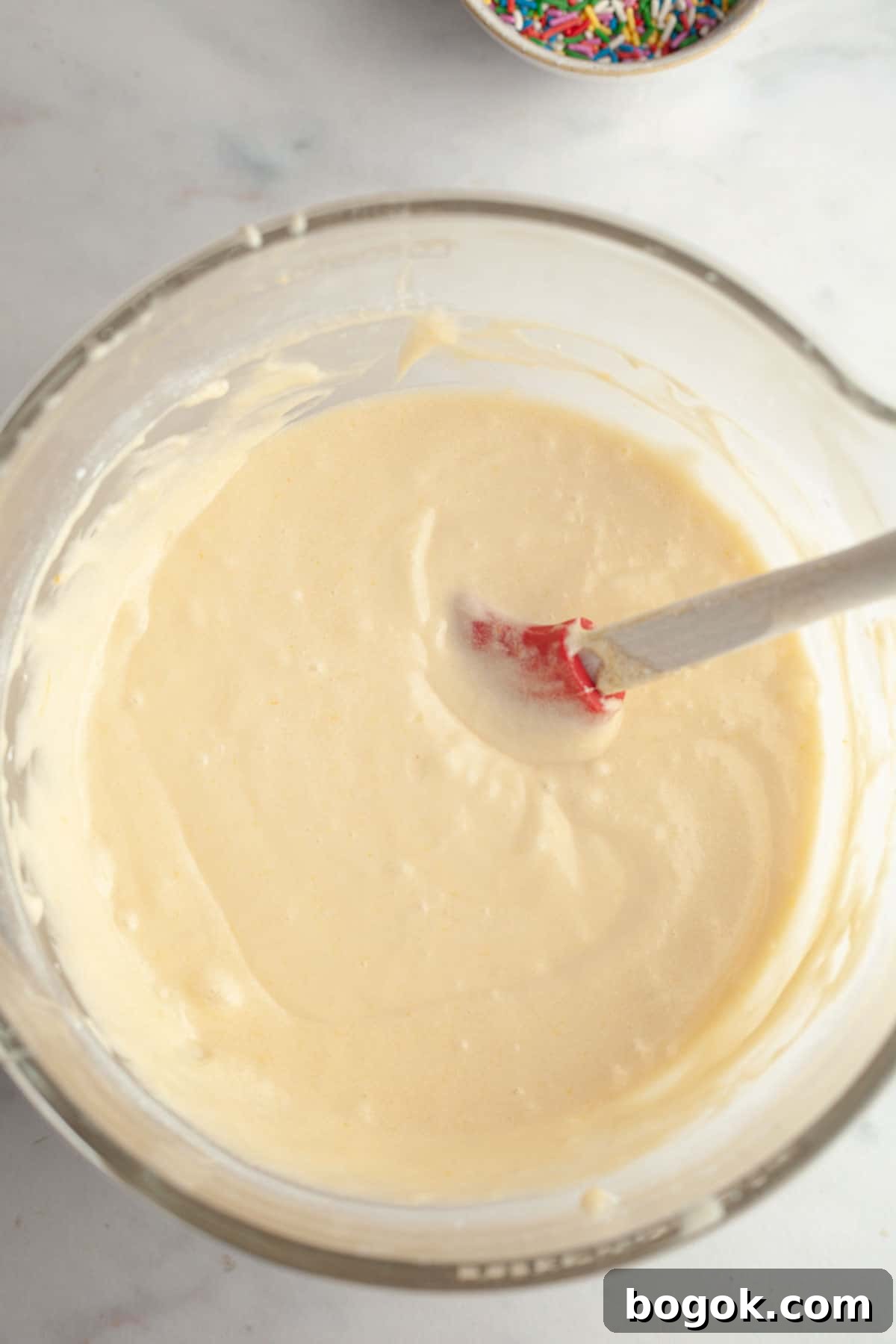Vanilla cake batter in a large bowl.