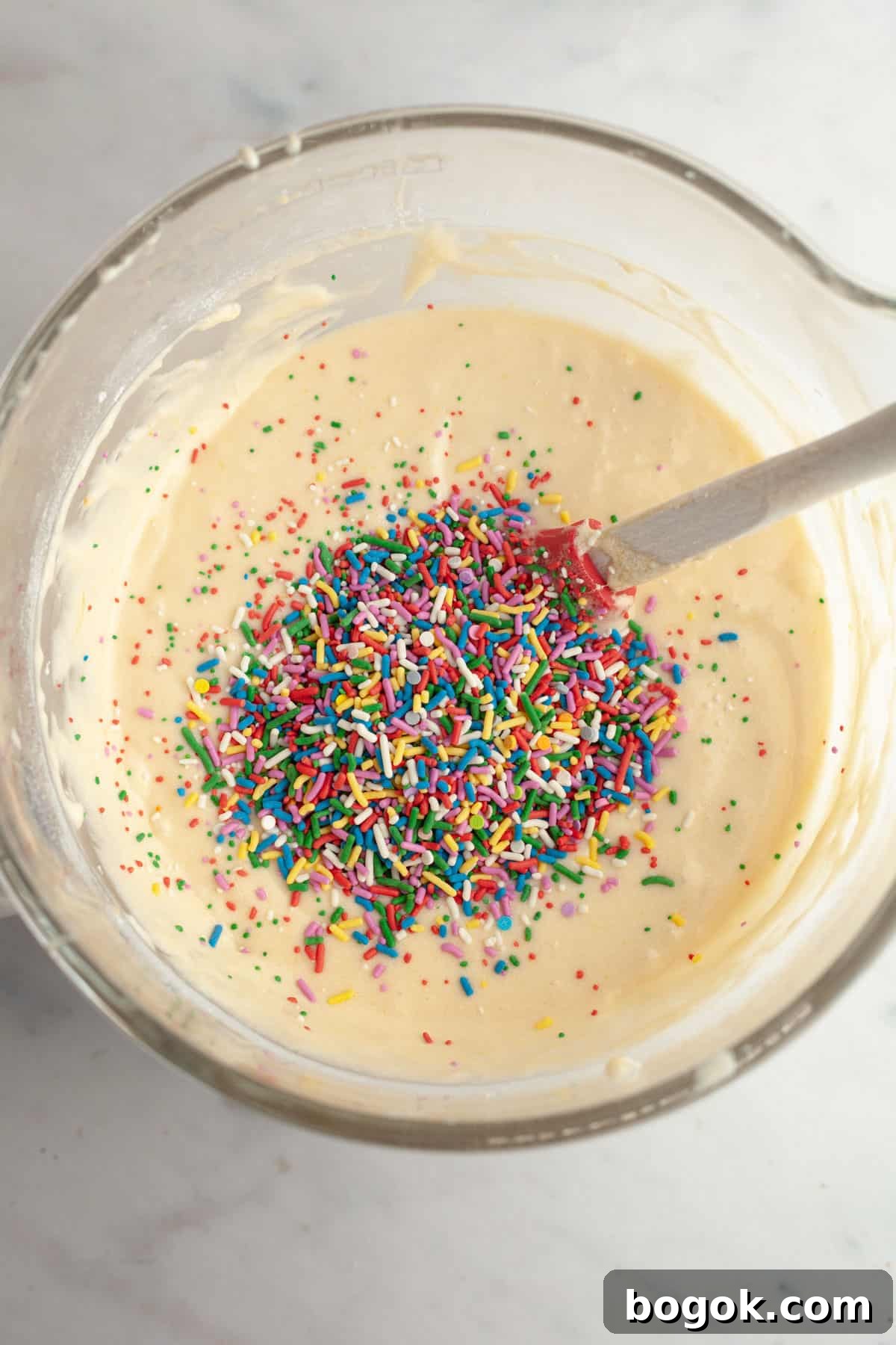 Cake batter in a bowl with sprinkles.