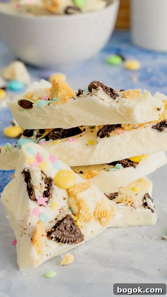 A stack of Easter Bunny Bark with a white chocolate base topped with cookies and candy.