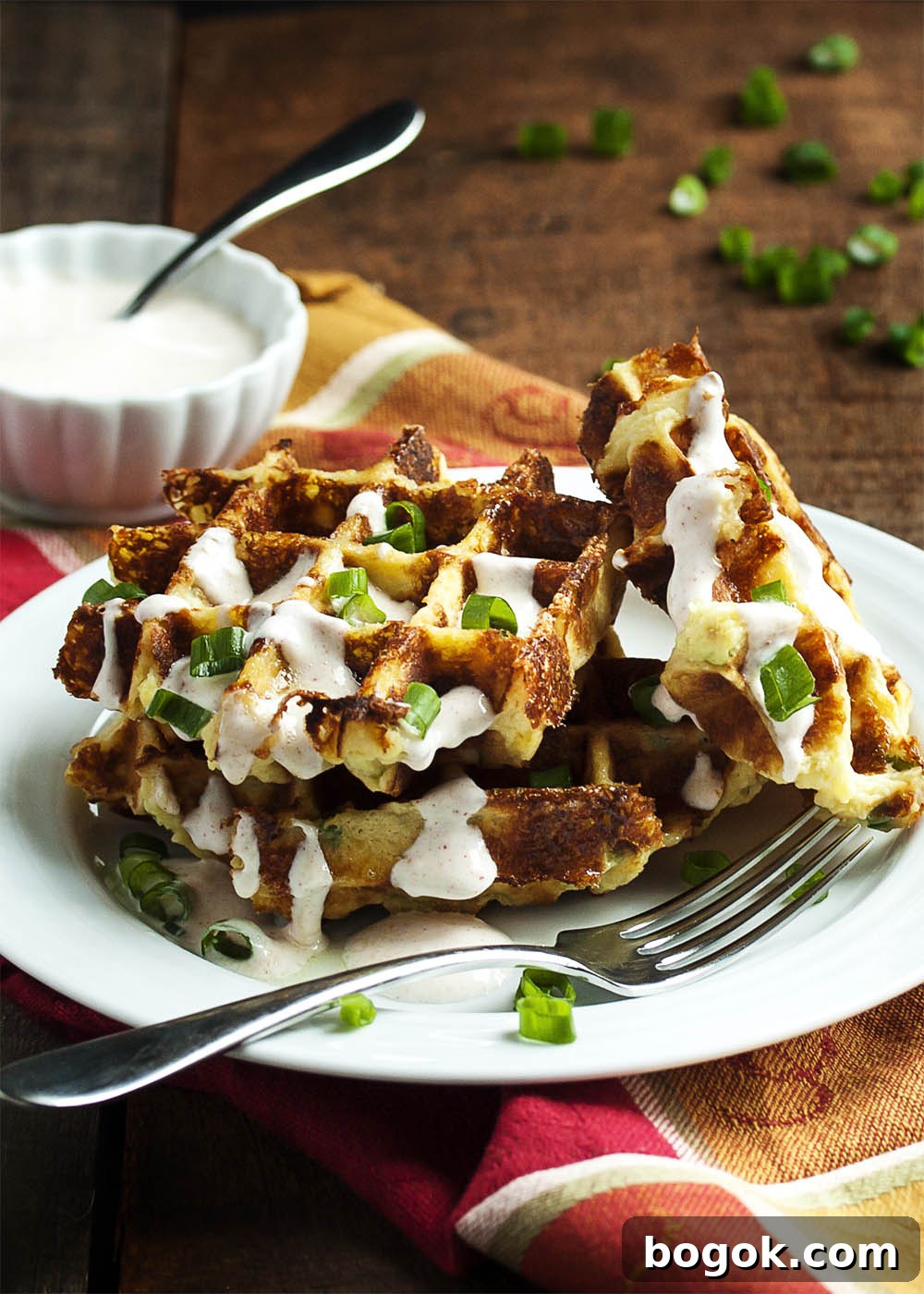 Loaded Mashed Potato Waffles - Mashed Potato Waffles are filled with scallions and cheese and are an awesomely tasty way to enjoy leftover mashed potatoes.