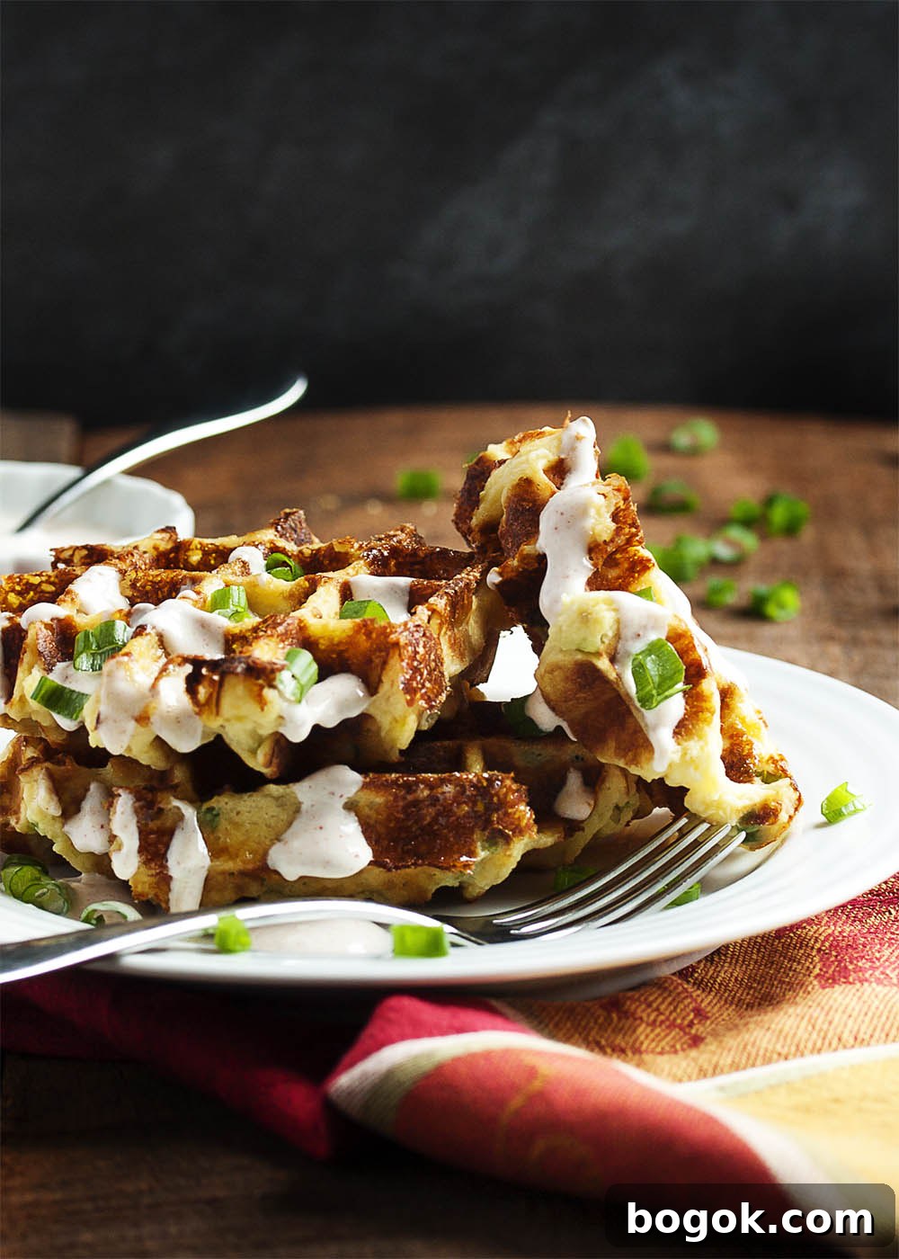 Loaded Mashed Potato Waffles - Mashed Potato Waffles are filled with scallions and cheese and are an awesomely tasty way to enjoy leftover mashed potatoes.