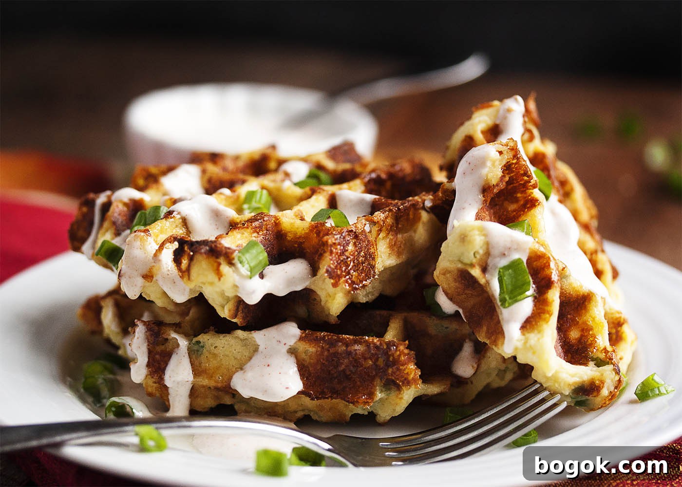 Loaded Mashed Potato Waffles - Mashed Potato Waffles are filled with scallions and cheese and are an awesomely tasty way to enjoy leftover mashed potatoes.