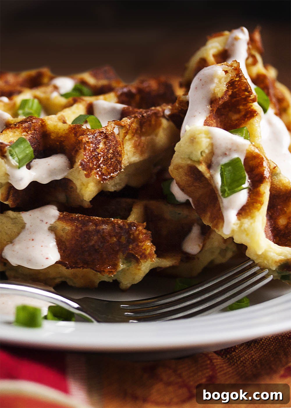 Loaded Mashed Potato Waffles - Mashed Potato Waffles are filled with scallions and cheese and are an awesomely tasty way to enjoy leftover mashed potatoes.