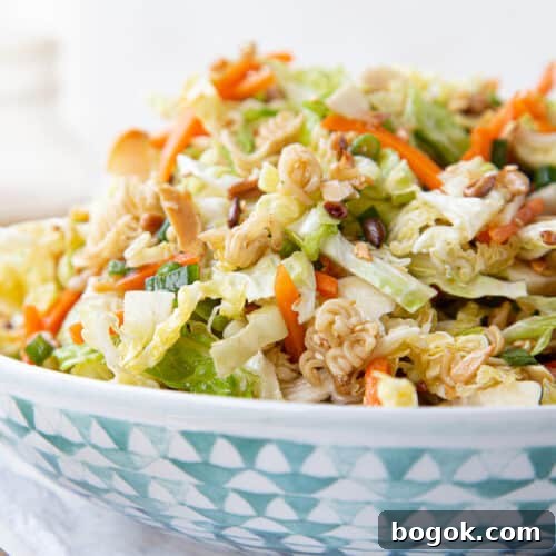 asian cabbage salad in a blue and white decorative bowl.