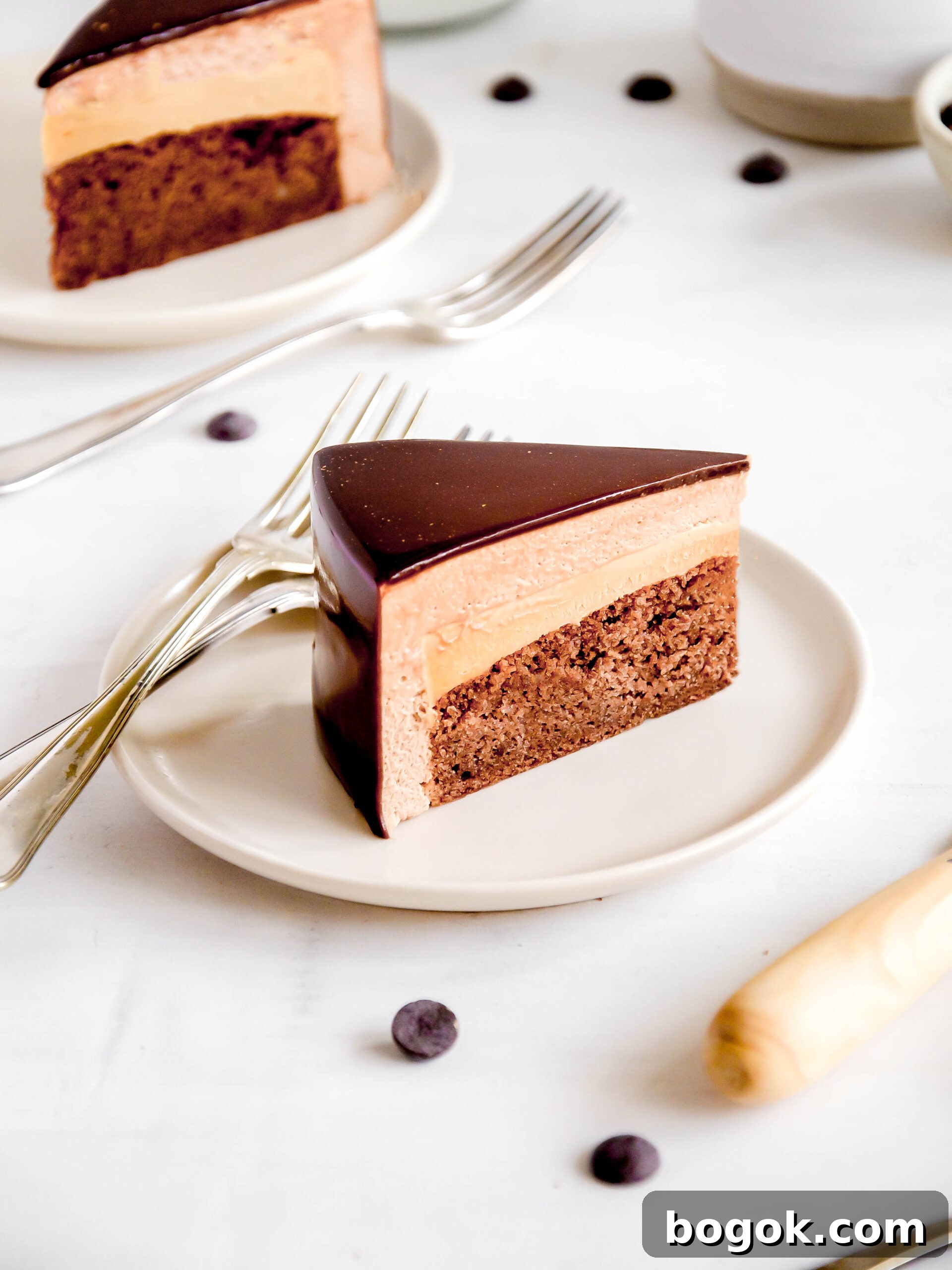 chocolate and caramel mousse cake slice on a plate.
