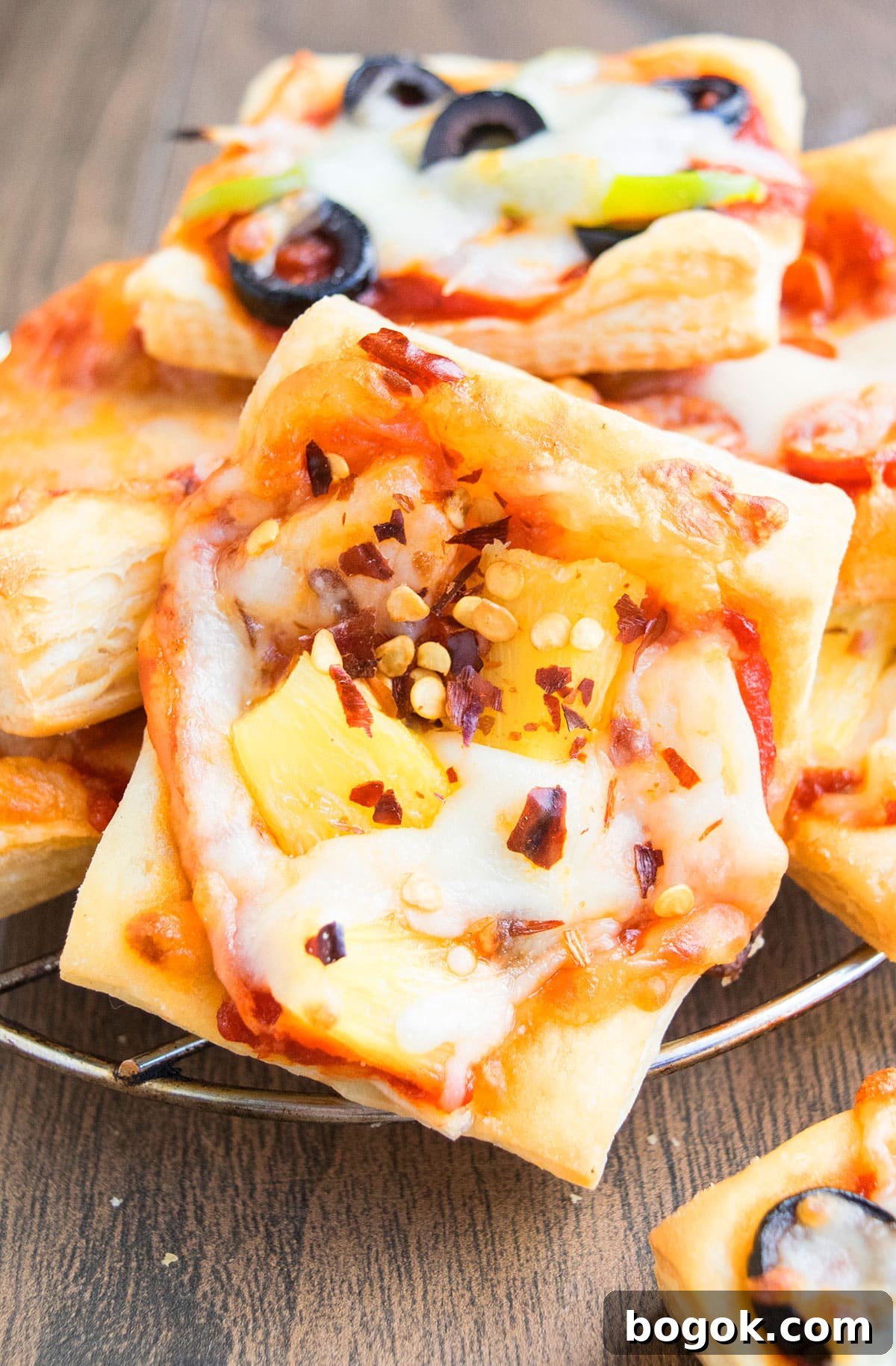 Closeup shot of pineapple, cheese and red chili flake toppings.