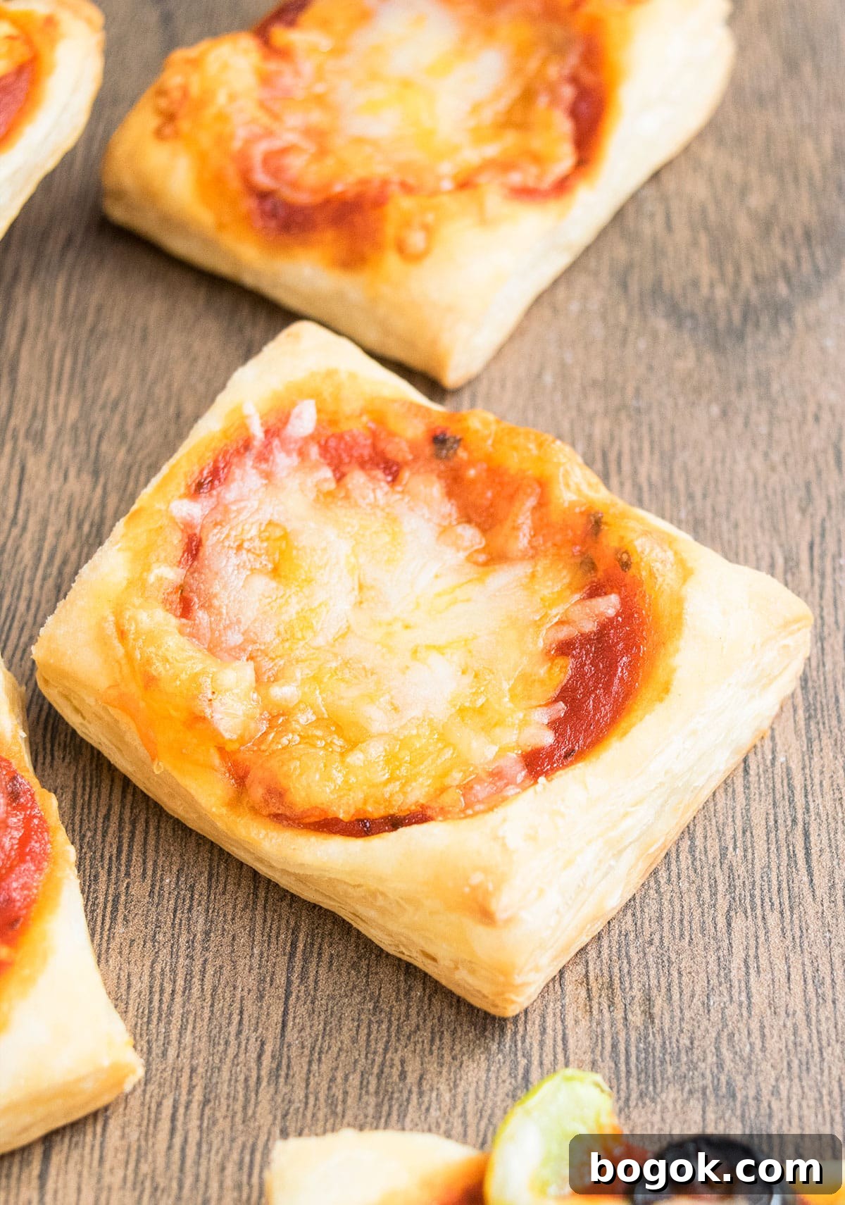 Mini pizza appetizer on wood background.