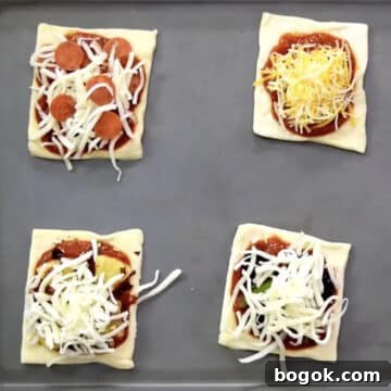 Mini square puffs with toppings on baking tray.