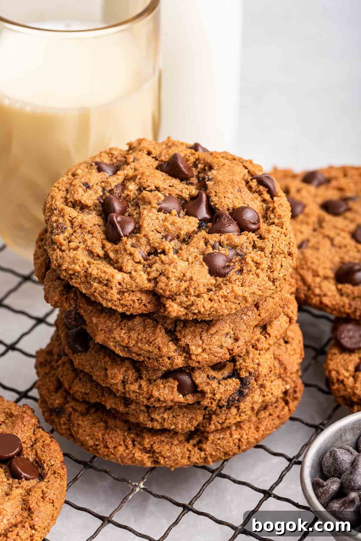 Stack of almond flour chocolate chip cookies on cooling rack.
