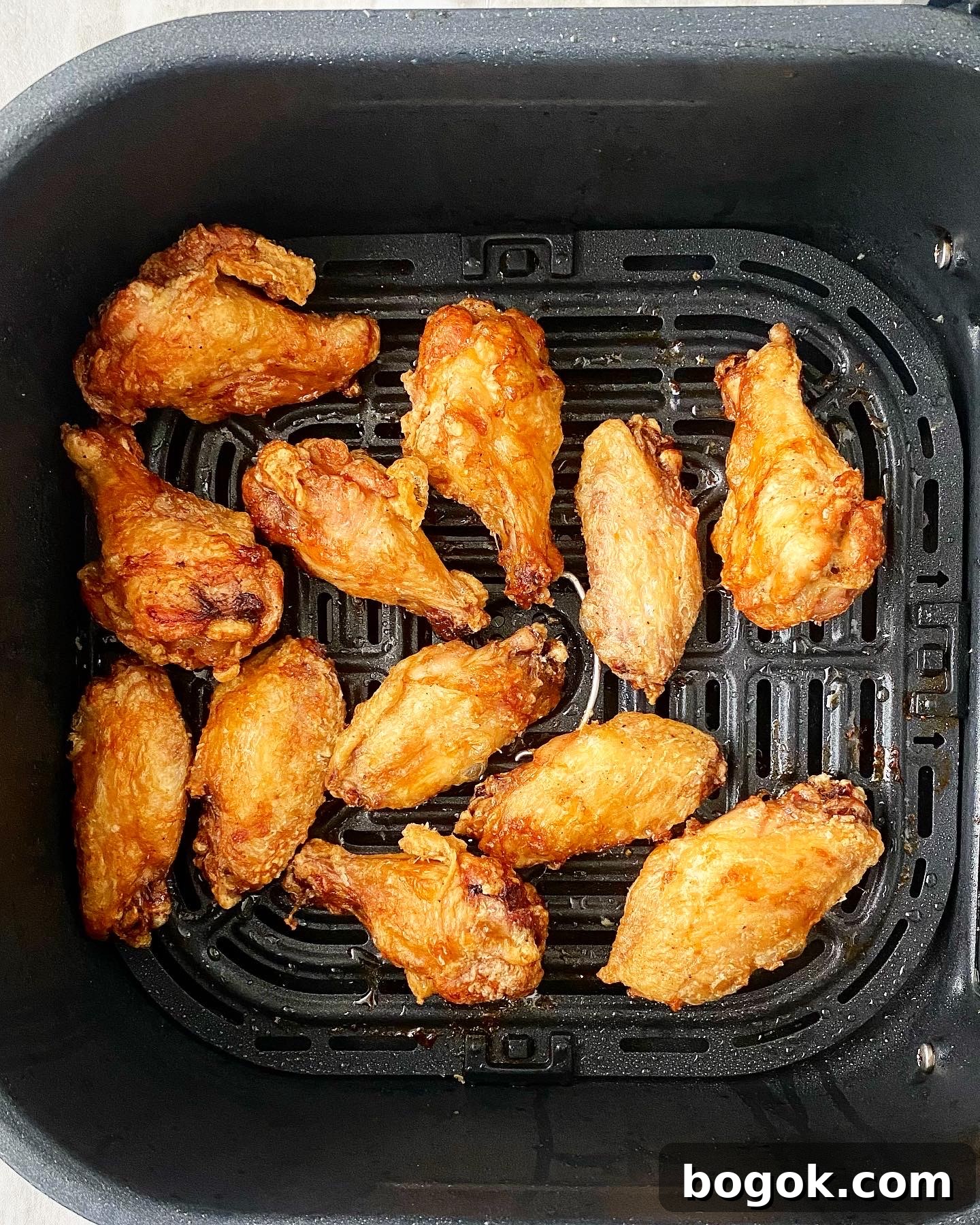 cooked air fryer buffalo chicken wings in the basket