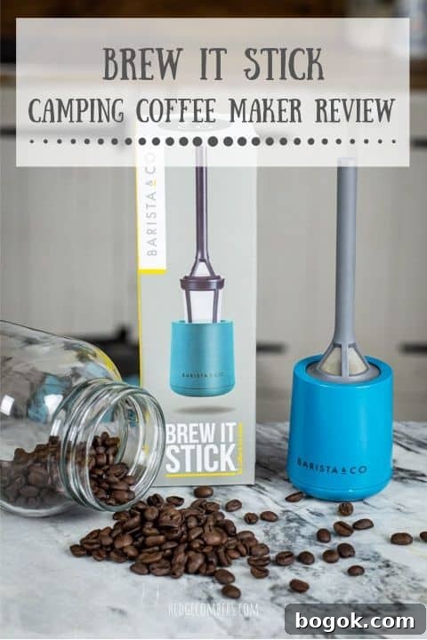 grey and blue plastic camping coffee maker laid out on marble surface with coffee beans and glass jar