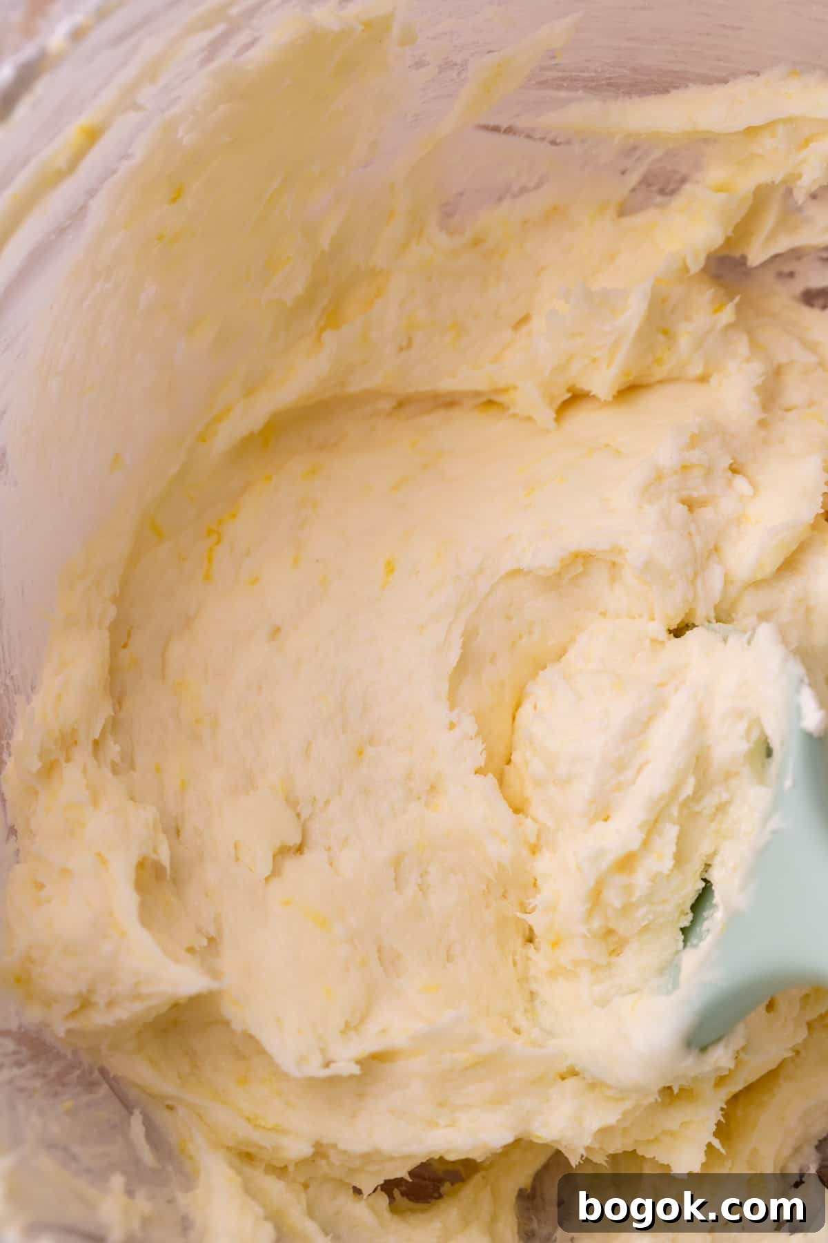 Lemon cream cheese frosting in a glass bowl.