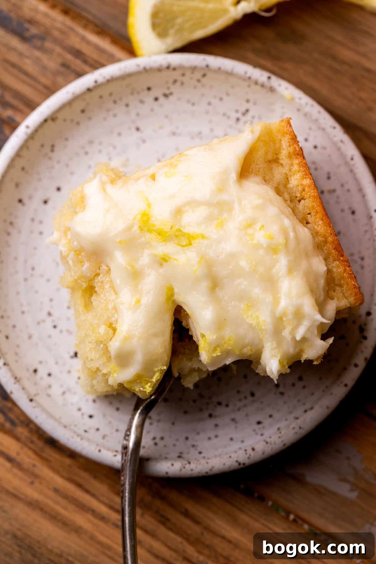 One slice of cake on a cake with a fork inserted.