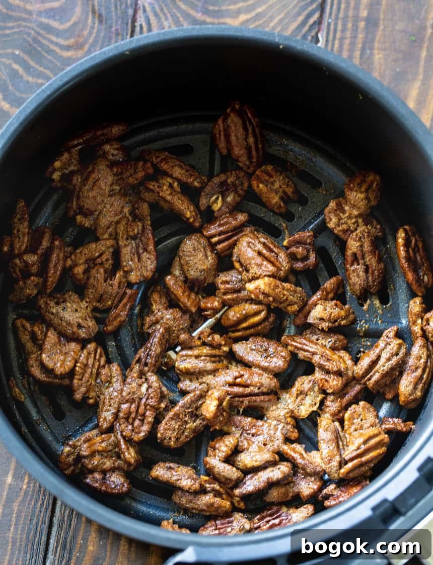 Sweet-and-Spicy Candied Pecans Recipe for Air Fryer 3 Pecans in air fryer basket.
