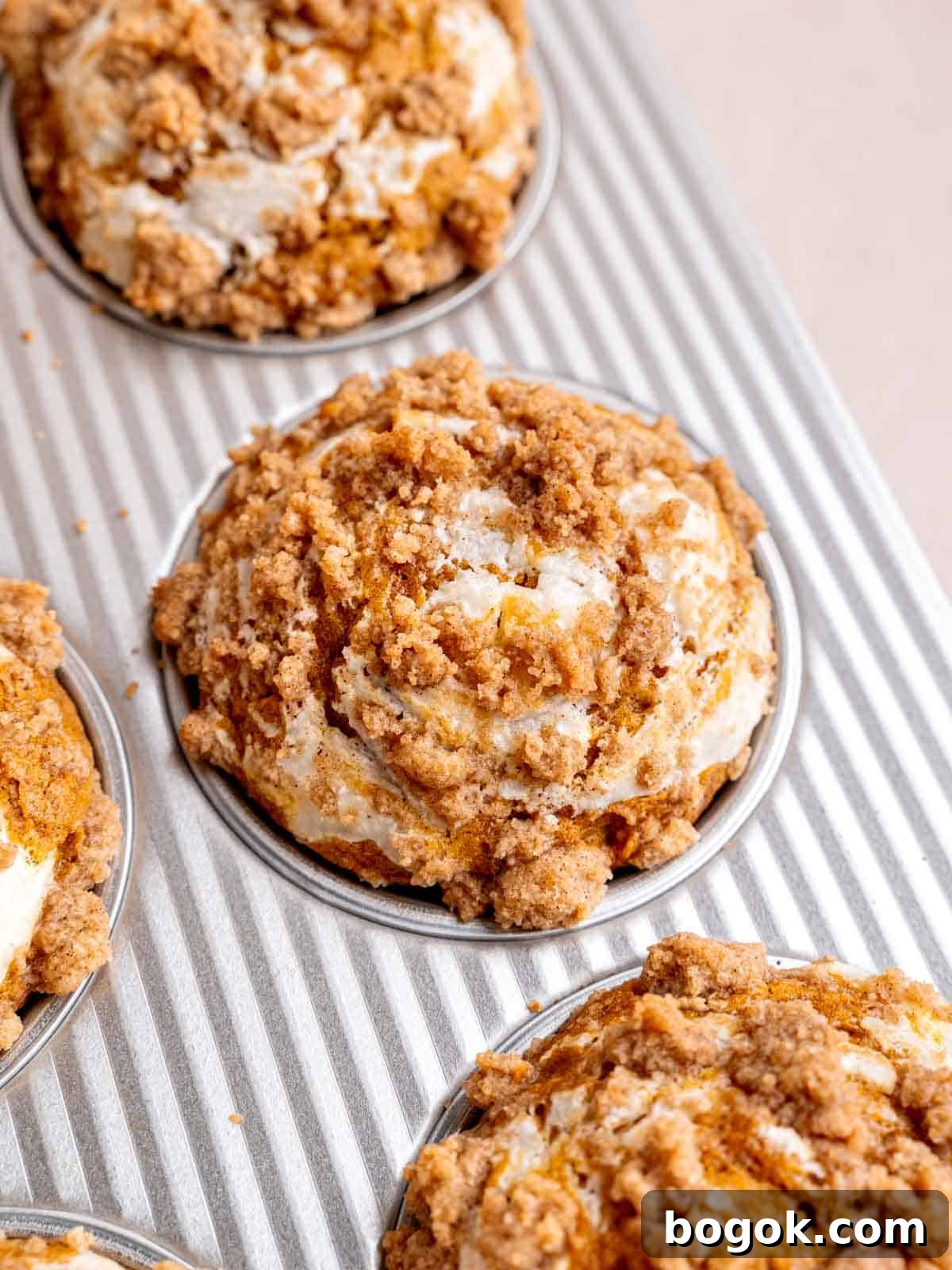 Pumpkin cream cheese muffins with streusel baked in a pan.