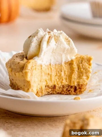 No bake pumpkin cheesecake with a bite taken out of it.